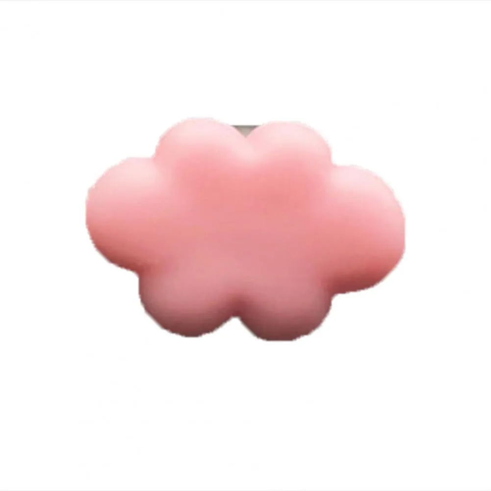 Resin cartoon car fragrance clip in pastel colours on a car air vent.