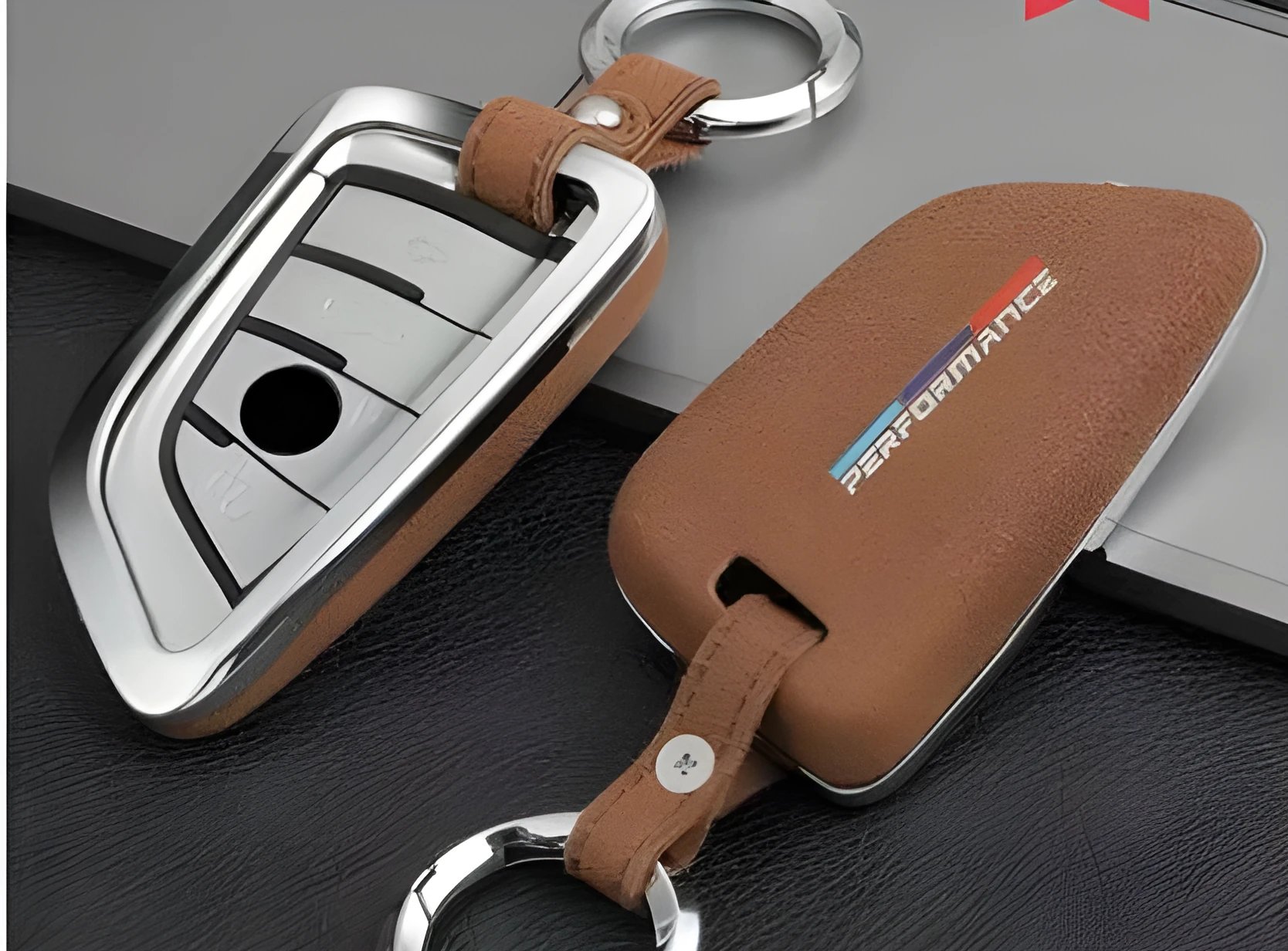 Suede key case with zinc alloy front frame in Classic Black, Charming Red, and Saddle Brown colour options