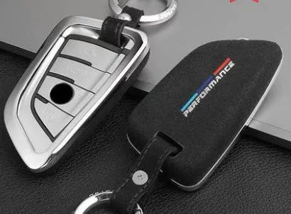 Suede key case with zinc alloy front frame in Classic Black, Charming Red, and Saddle Brown colour options