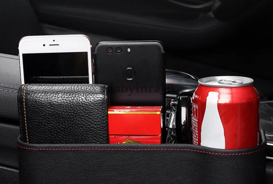 PU leather car seat gap storage box in black holding a smartphone and wallet between the console and seat