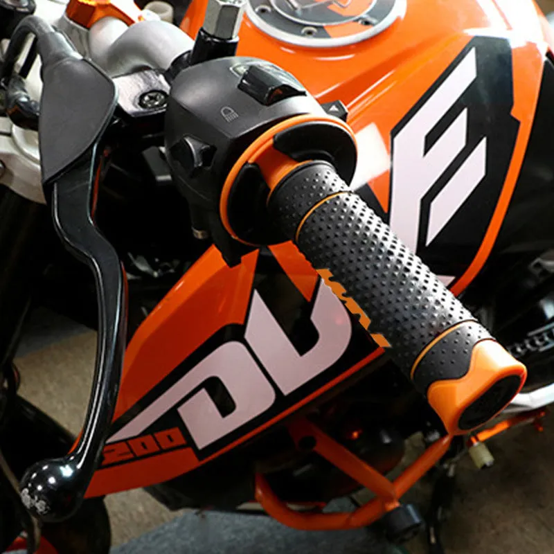 Pair of black and orange rubber motorcycle handle covers for KTM off-road bikes, shown on handlebars