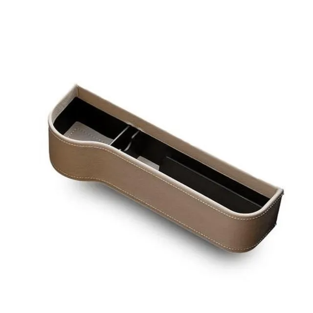 PU leather car seat gap storage box in black, showing phone and cup storage between seat and console
