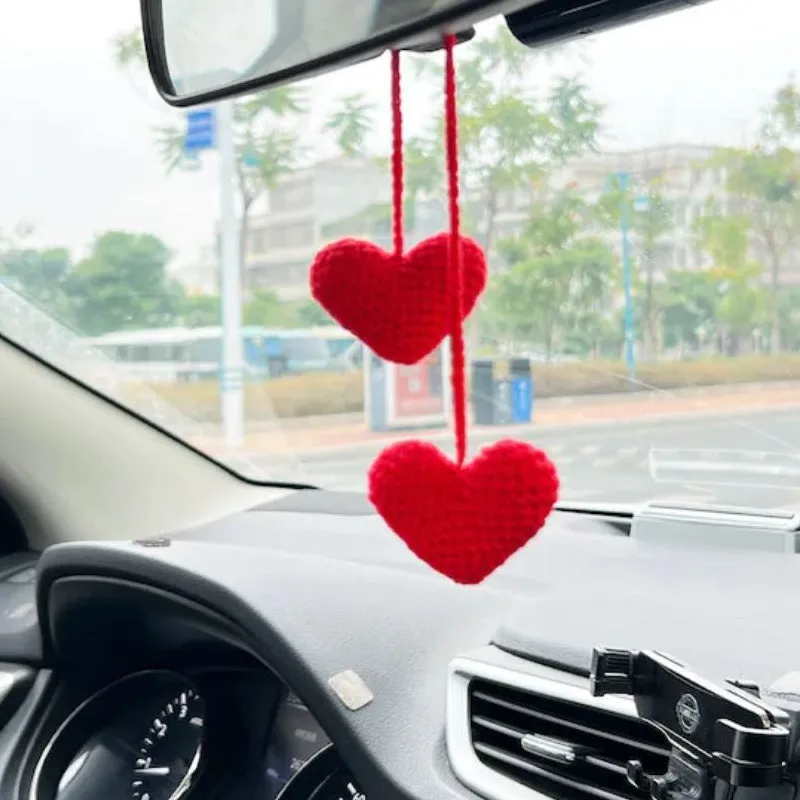 Green and white knitted wool car plant ornament with hanging rope.