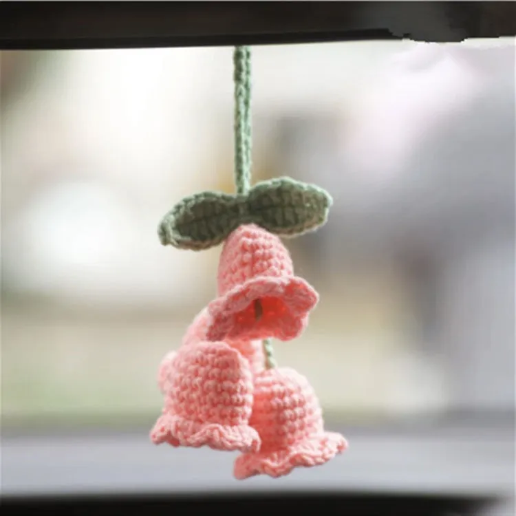 Green and white knitted wool car plant ornament with hanging rope.