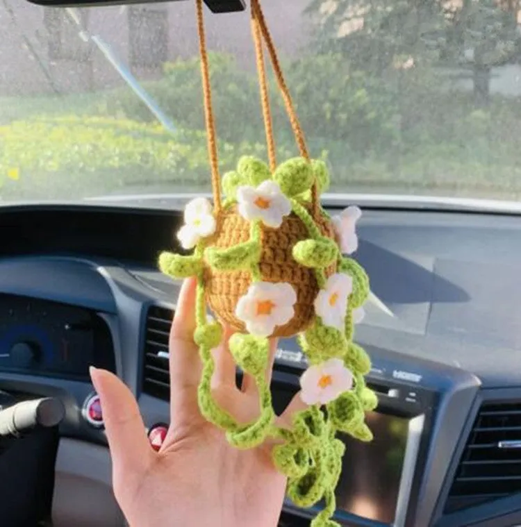 Green and white knitted wool car plant ornament with hanging rope.