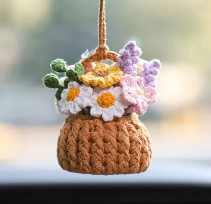 Green and white knitted wool car plant ornament with hanging rope.