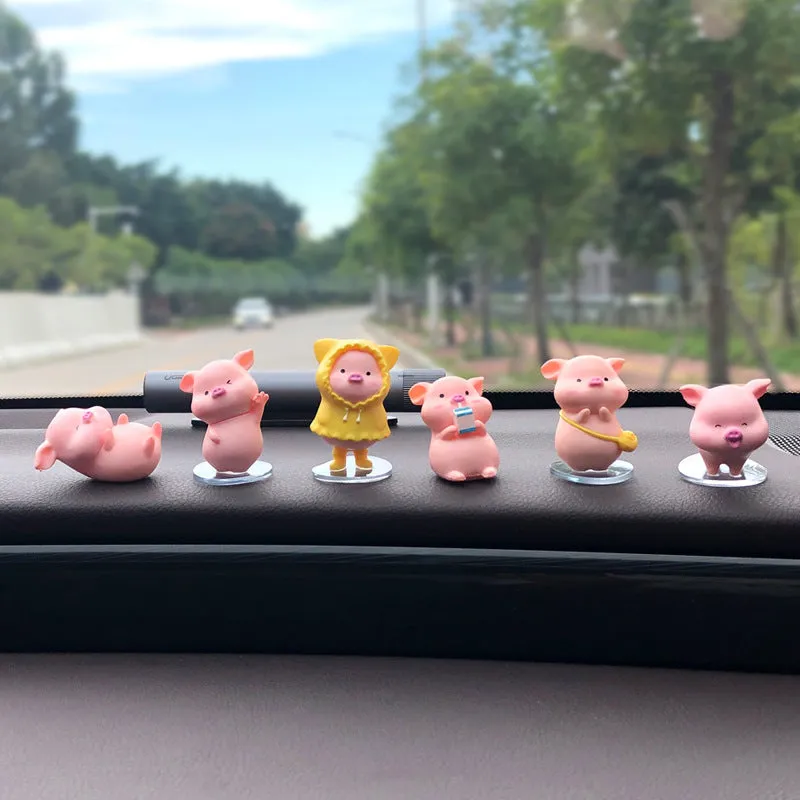 Six little pink resin pigs with colourful balloons on a rectangular anti-skid pad, cartoon car decoration