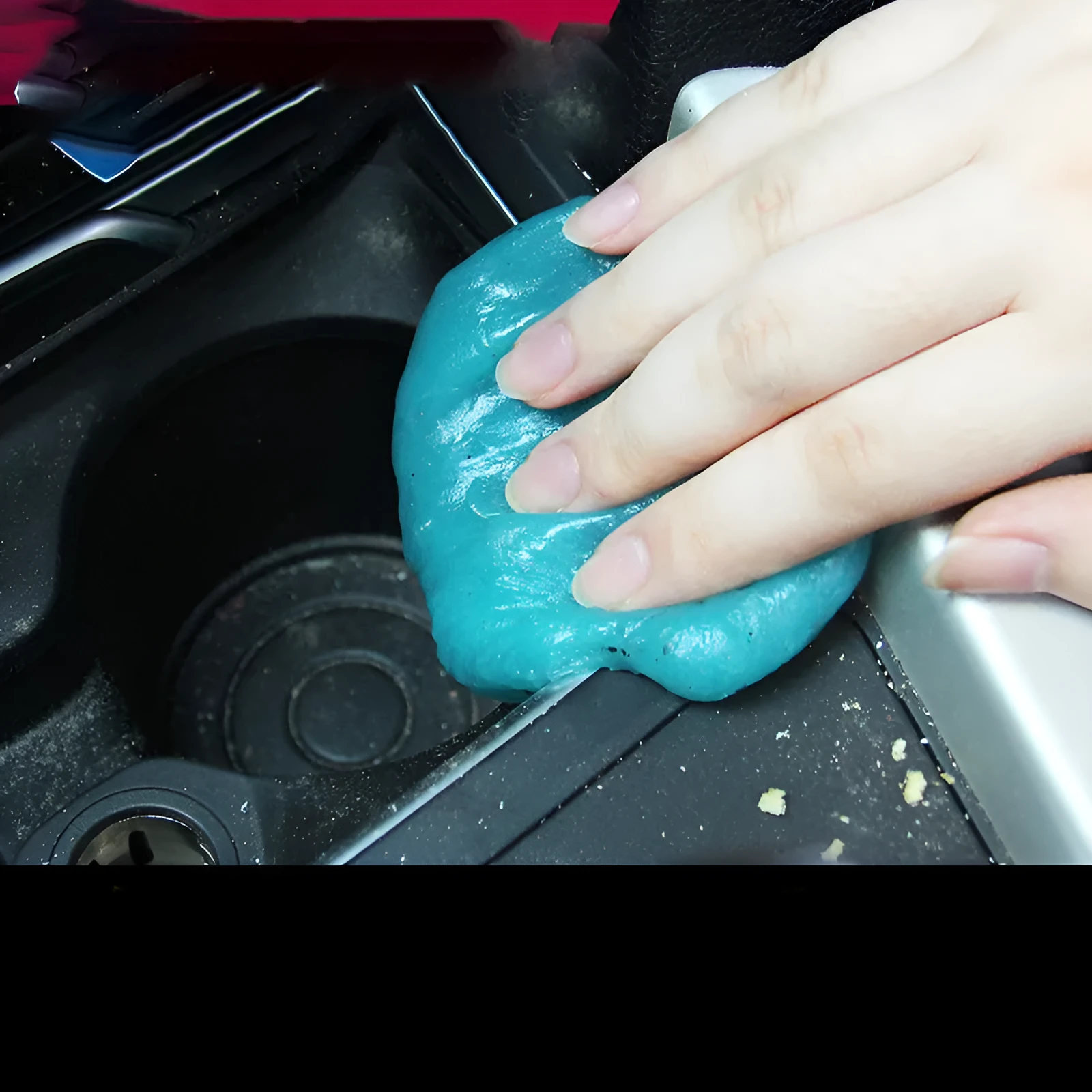 Multifunctional cleaning soft gel in blue and yellow on a car dashboard