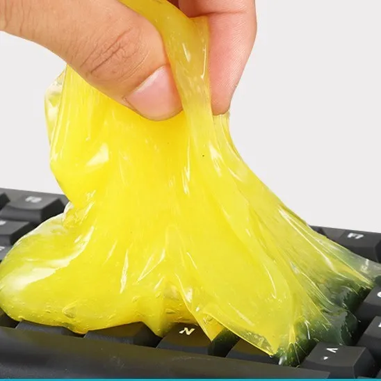 Multifunctional cleaning soft gel in blue and yellow on a car dashboard