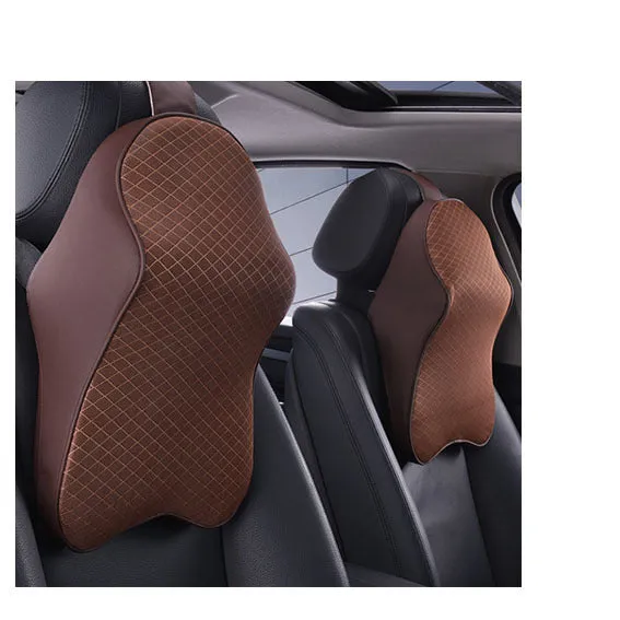 Memory foam car neck pillow with ergonomic shape, adjustable strap, and polyester cover on a car seat