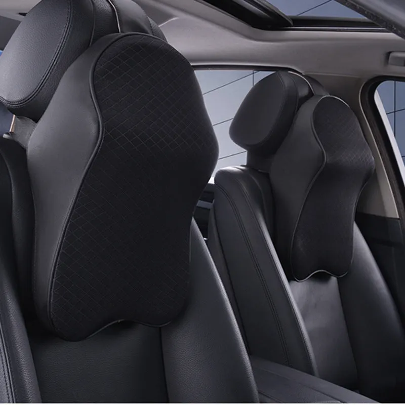 Memory foam car neck pillow with ergonomic shape, adjustable strap, and polyester cover on a car seat