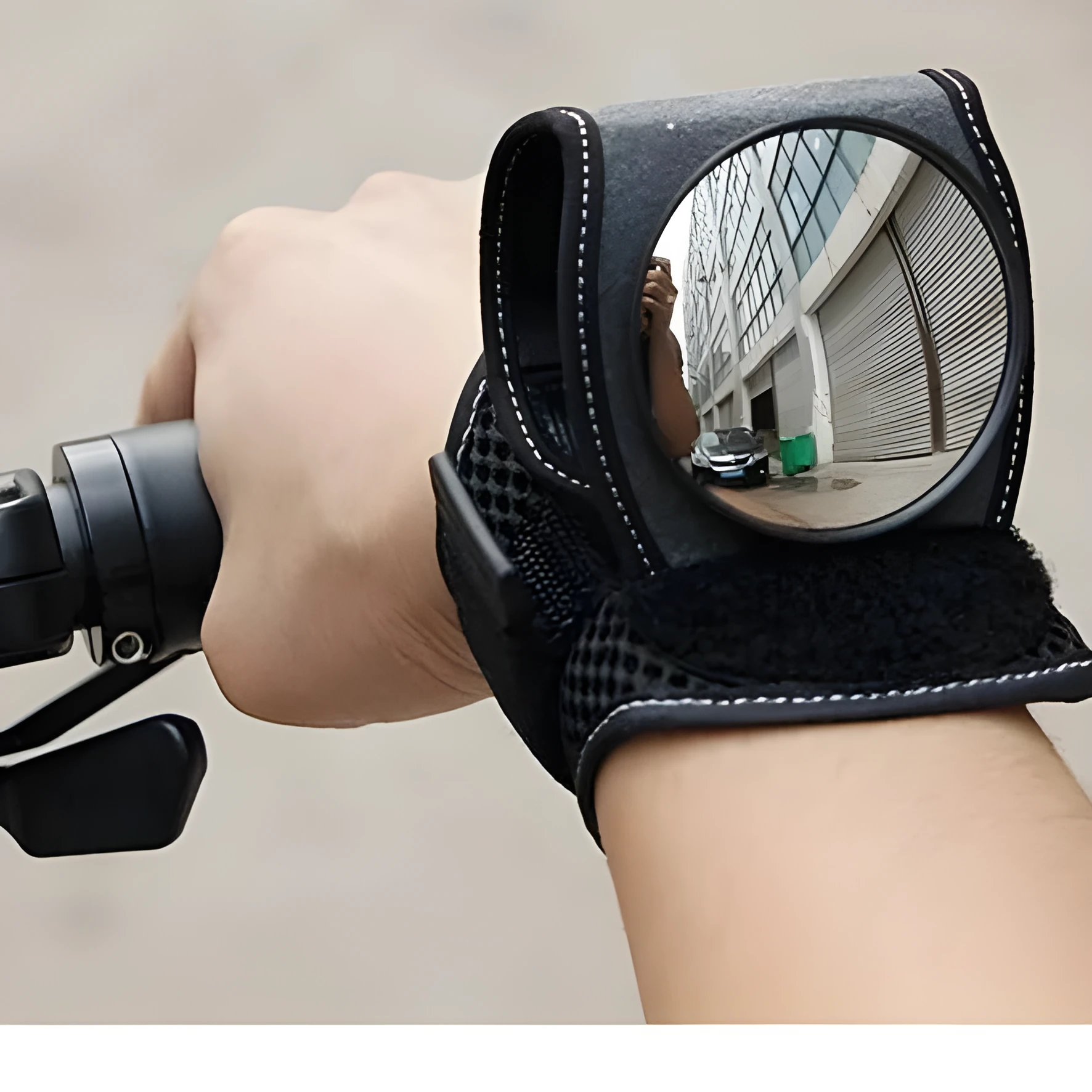 Bicycle wrist safety mirror with adjustable strap and anti-slip pad on a cyclist's wrist