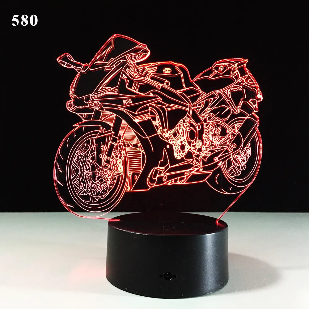 Motorcycle LED desk lamp with black base and acrylic shade on a wooden desk, 220x130x90mm
