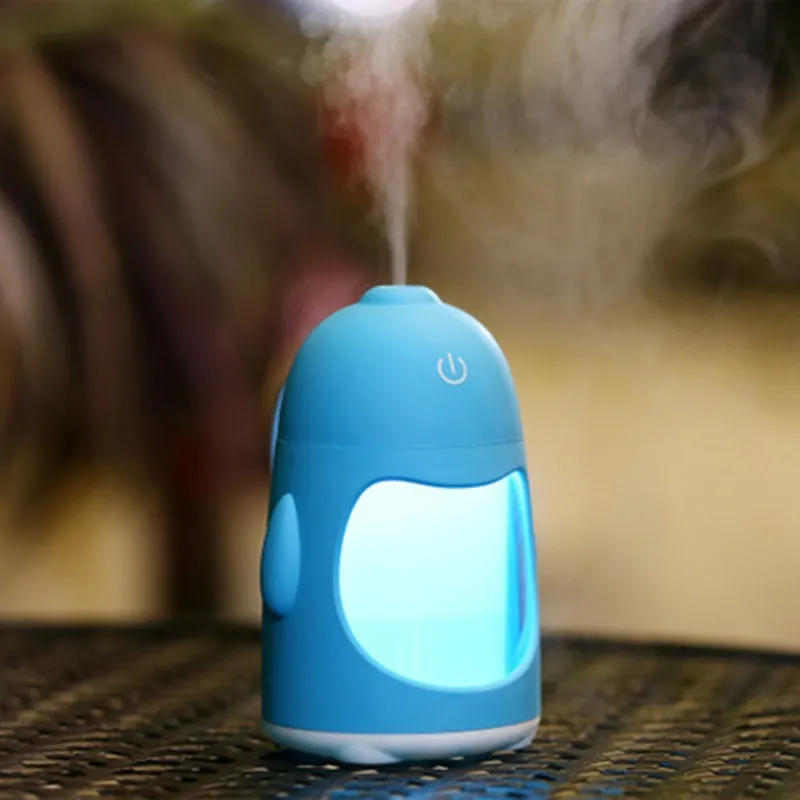 Penguin car humidifier with blue body, USB cable, and mist coming from the top