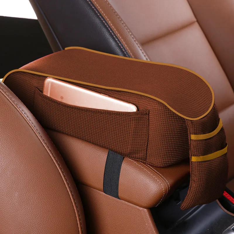 Sports knitted fabric car armrest box pad in Black Red colour on a car centre console. Measures 16x30cm.