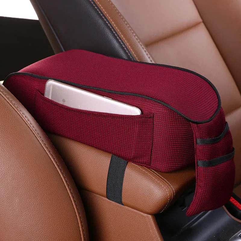 Sports knitted fabric car armrest box pad in Black Red colour on a car centre console. Measures 16x30cm.