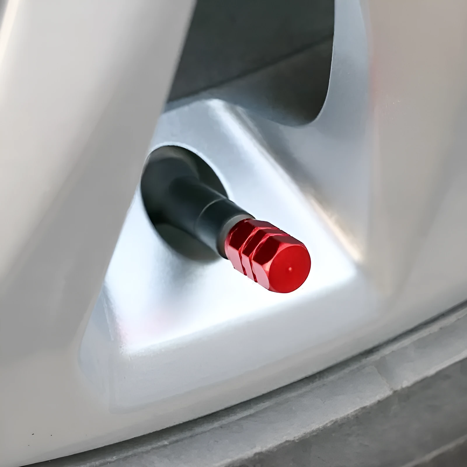 Set of ten aluminium alloy car valve caps in blue, red, silver, gold and black on a white background