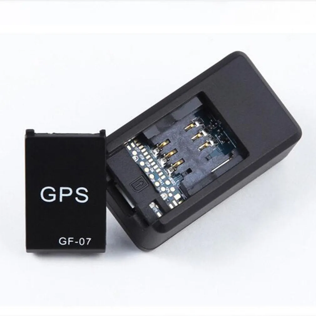 Small black magnetic GPS tracker device next to a USB charging cable.