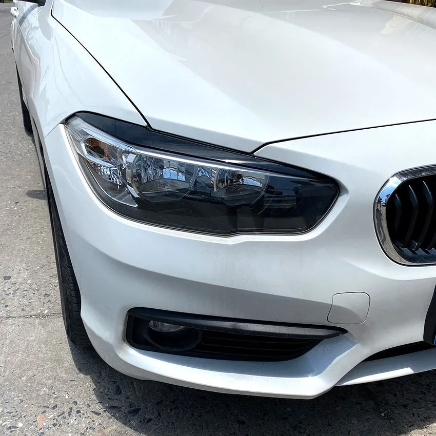 Pair of ABS headlight eyebrow stickers for BMW 1 Series F20, piano black finish, 48x8x8 cm