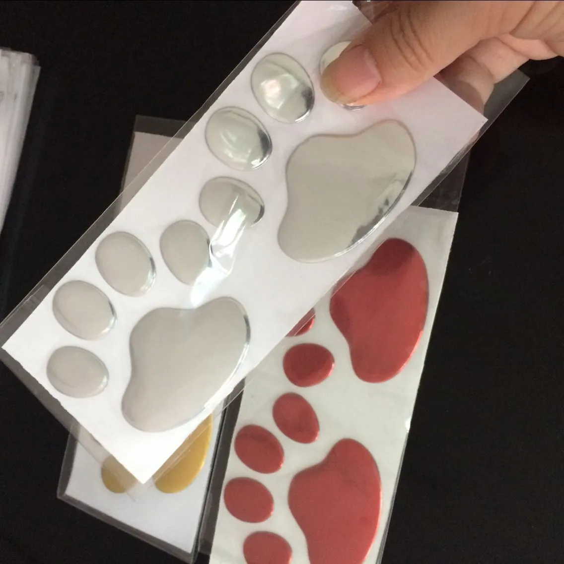 PVC dog footprint car sticker showing hand-shaped brush design on vehicle bumper