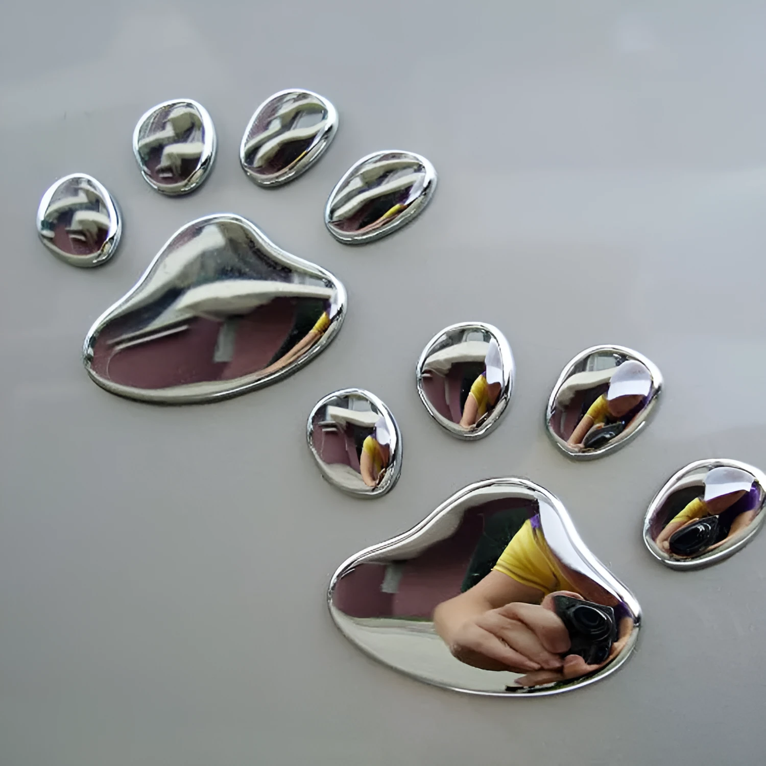 PVC dog footprint car sticker showing hand-shaped brush design on vehicle bumper