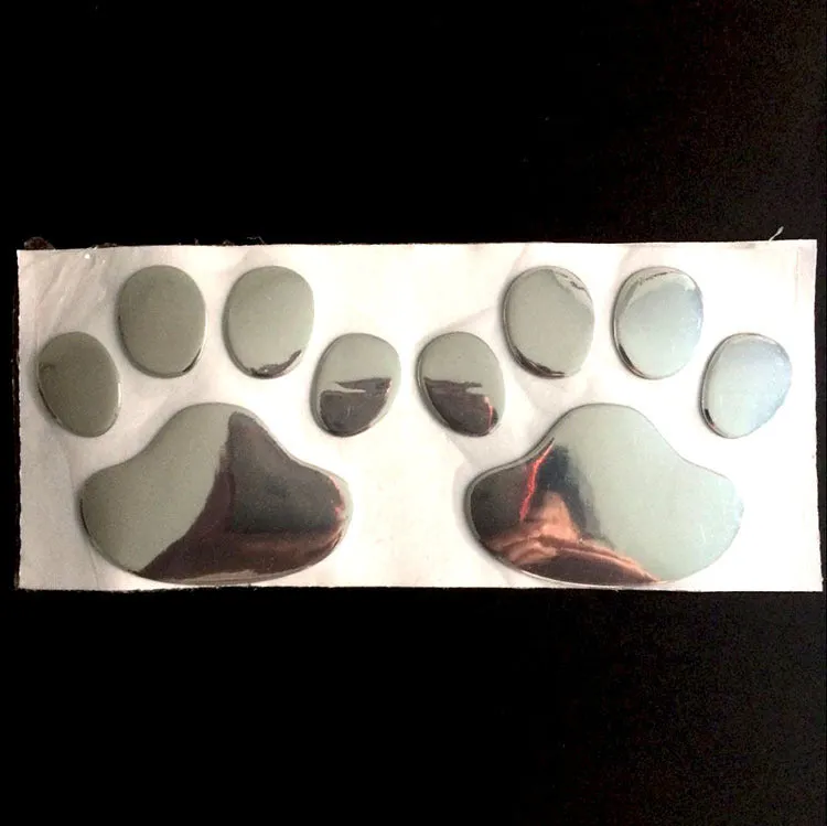 PVC dog footprint car sticker showing hand-shaped brush design on vehicle bumper