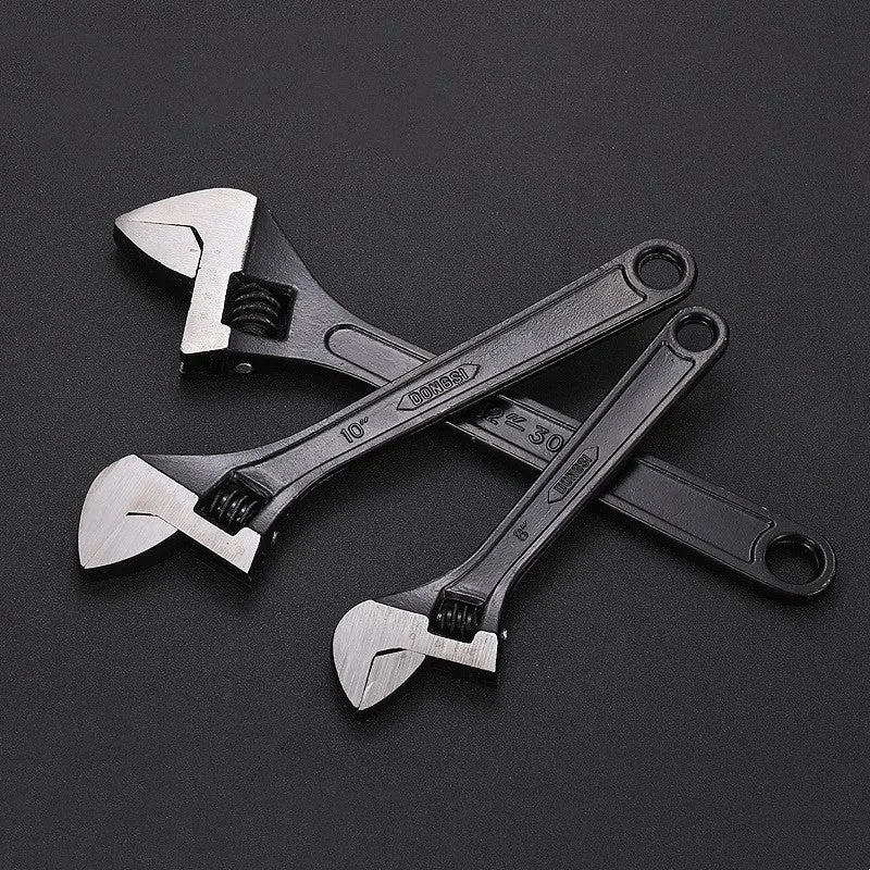10-inch black high carbon steel adjustable open-end wrench on a workbench