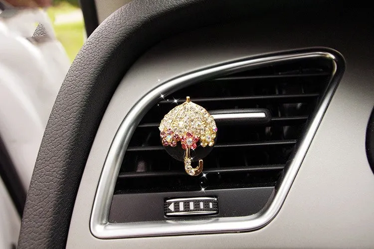 Alloy car fragrance clip with decorative charm attached to car air vent