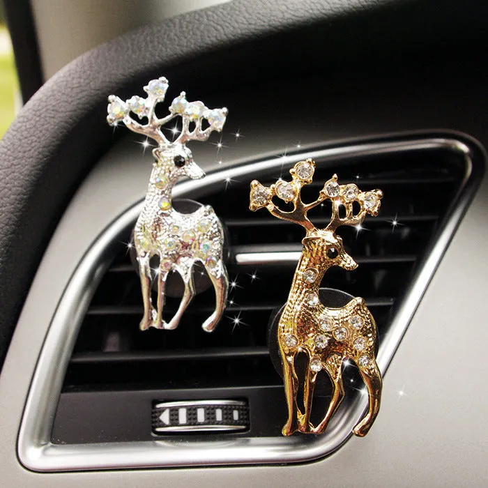 Alloy car fragrance clip with decorative charm attached to car air vent