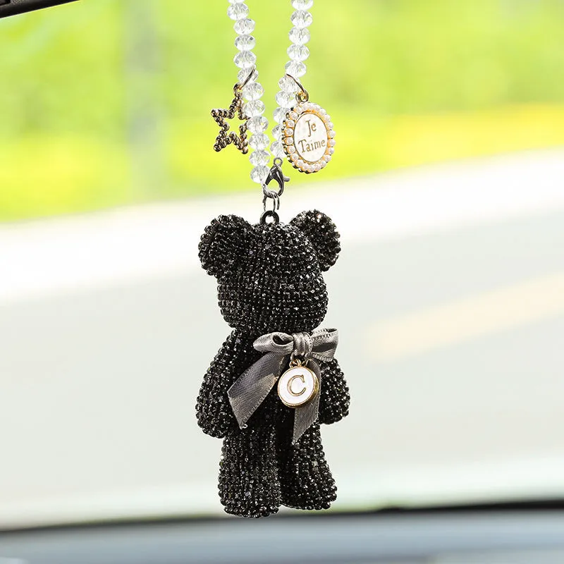 Black violent bear car mirror pendant with embedded crystal rhinestones on a white background.