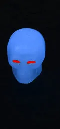 Luminous skull-shaped rubber car tyre valve cap in glow effect on a standard wheel