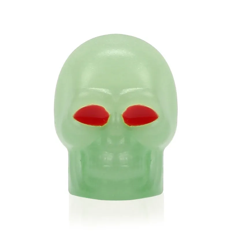 Luminous skull-shaped rubber car tyre valve cap in glow effect on a standard wheel
