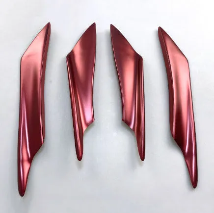 Set of four ABS plastic bumper air knife spoilers in a carbon fibre finish for car modification.