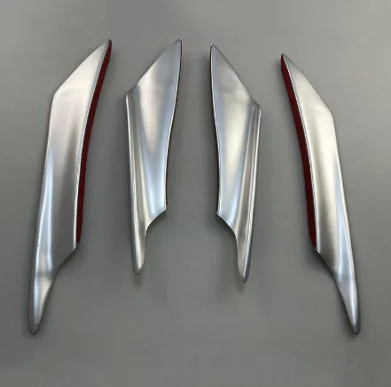 Set of four ABS plastic bumper air knife spoilers in a carbon fibre finish for car modification.