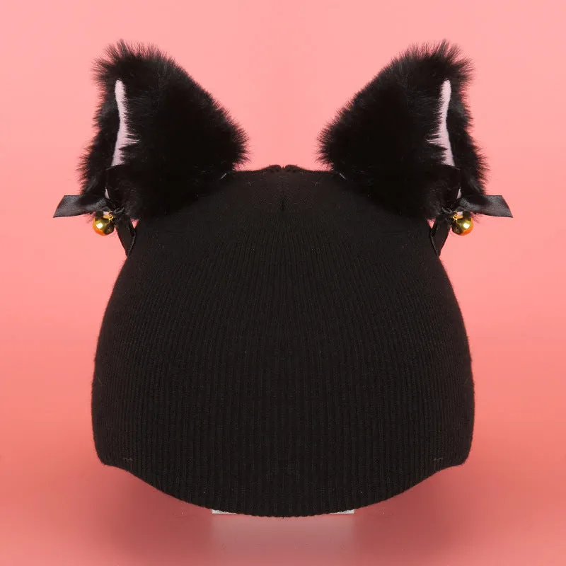 A soft plush cartoon character cover placed over a ski helmet on a snowy background.