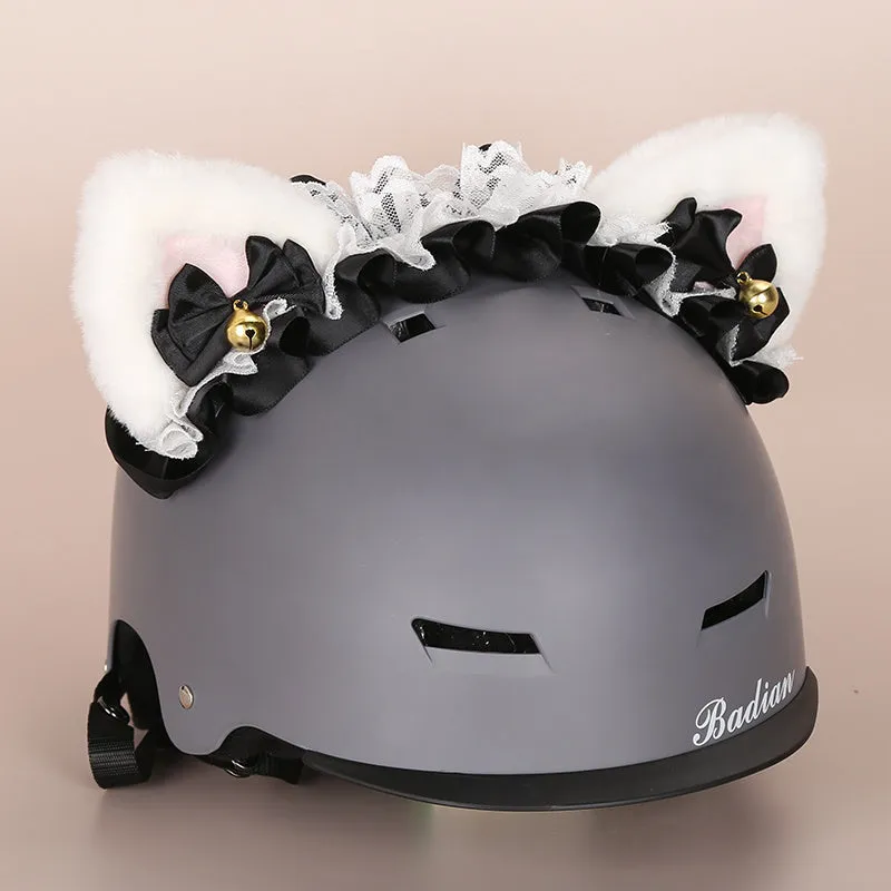 A soft plush cartoon character cover placed over a ski helmet on a snowy background.