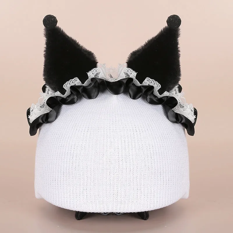 A soft plush cartoon character cover placed over a ski helmet on a snowy background.