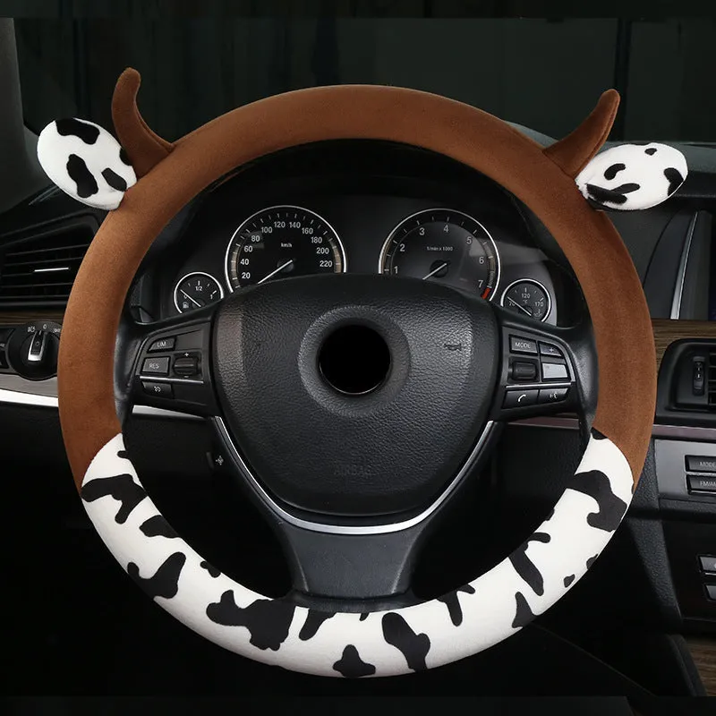 Short plush steering wheel cover with protective handle section in black colour