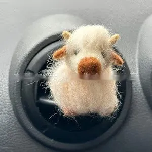 Scottish Highland Niutong air outlet clip in white plastic on a car dashboard vent
