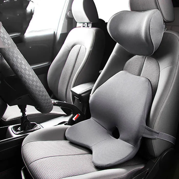 Car seat cushion with integrated memory foam waist pad and optional attached headrest in a neutral colour.
