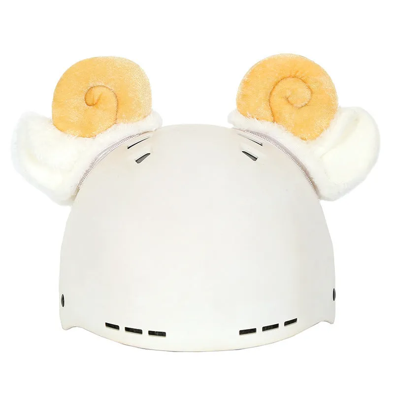 A plush fabric helmet cover with cartoon print and 3D ears, next to a matching beanie hat, on a neutral background.