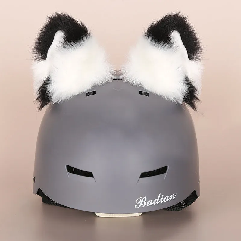 A plush fabric helmet cover with cartoon print and 3D ears, next to a matching beanie hat, on a neutral background.