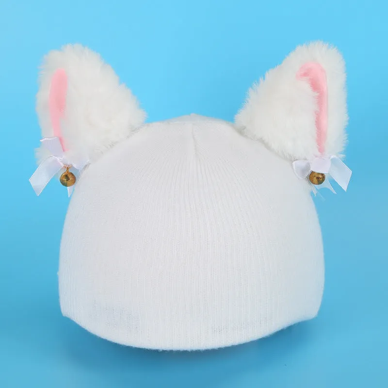 A plush fabric helmet cover with cartoon print and 3D ears, next to a matching beanie hat, on a neutral background.