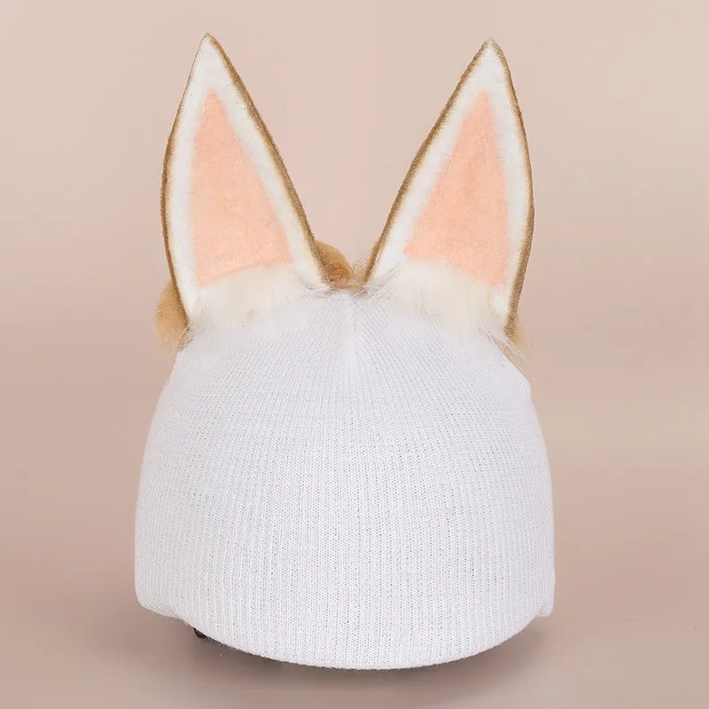 A plush fabric helmet cover with cartoon print and 3D ears, next to a matching beanie hat, on a neutral background.