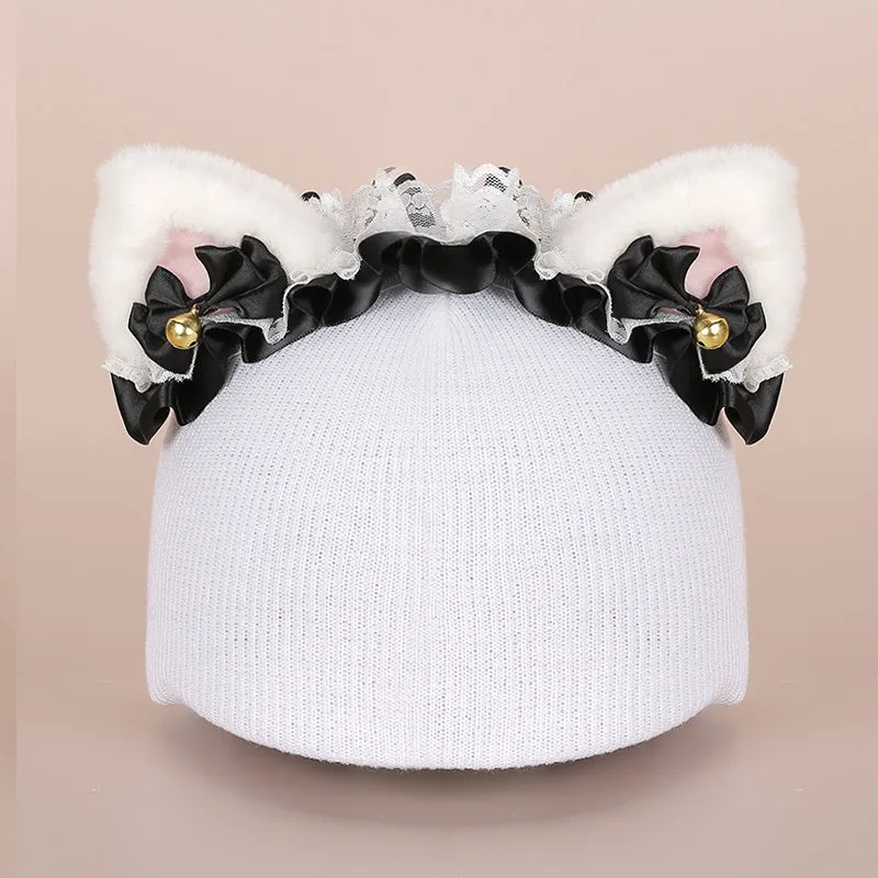 A plush fabric helmet cover with cartoon print and 3D ears, next to a matching beanie hat, on a neutral background.