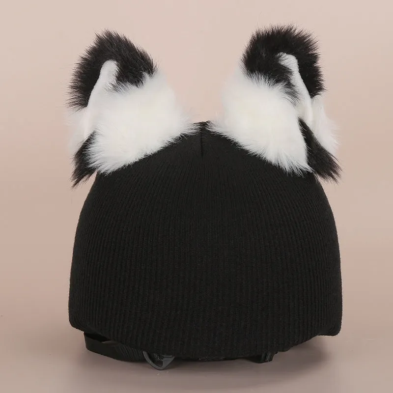 A plush fabric helmet cover with cartoon print and 3D ears, next to a matching beanie hat, on a neutral background.
