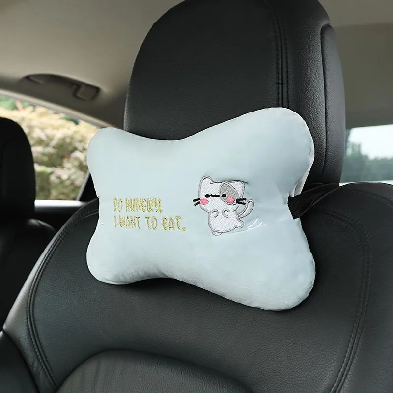 Car plush embroidery headrest shoulder pad with cute lion design in black on a car seat