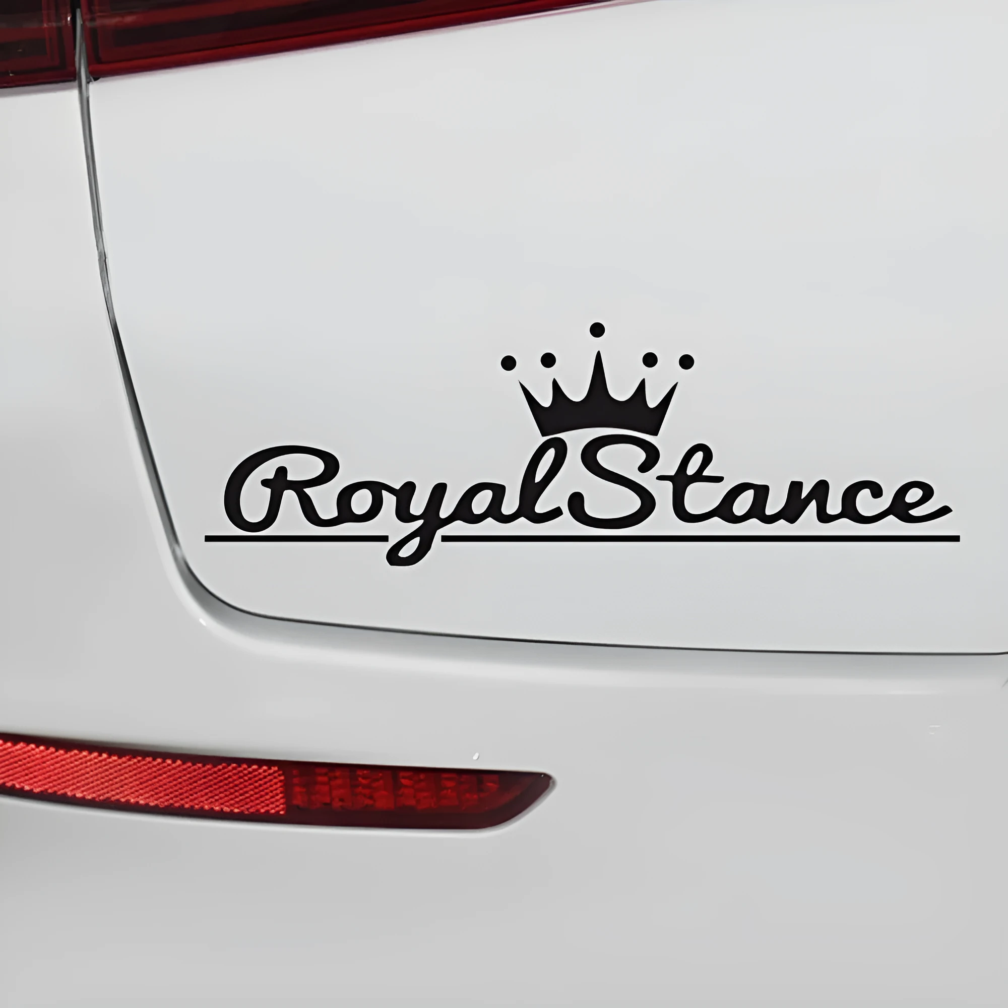 Reflective crown-shaped car sticker on vehicle windscreen showing colourful vinyl design