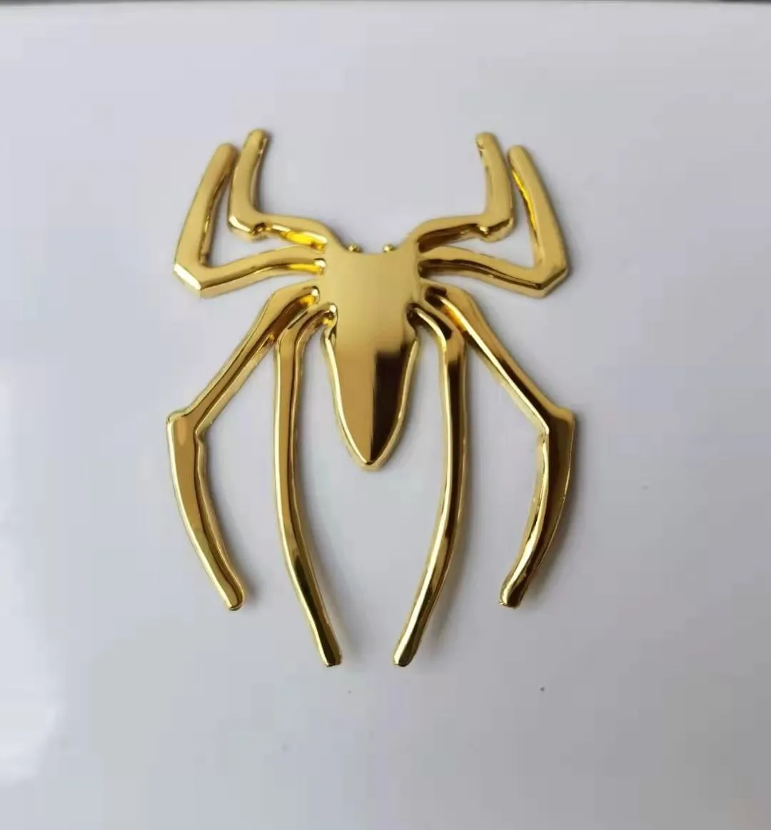Three-dimensional metal spider bumper sticker in metallic finish measuring 7cm by 5cm