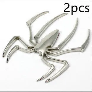 Three-dimensional metal spider bumper sticker in metallic finish measuring 7cm by 5cm